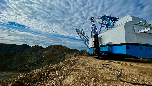 dragline sitting at the edge of an open pit mine for limestone 
