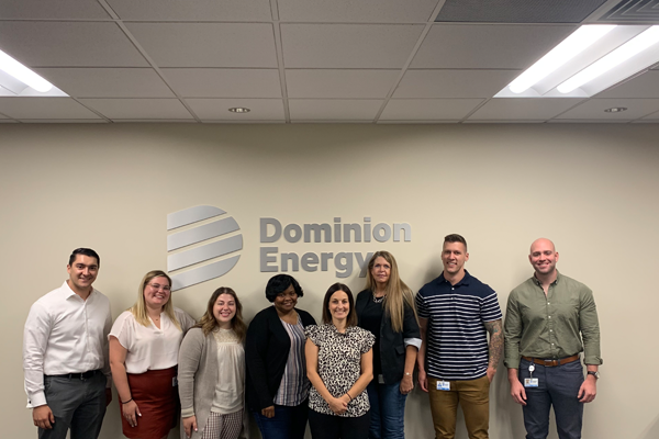 Group photo in front of Dominion Energy sign