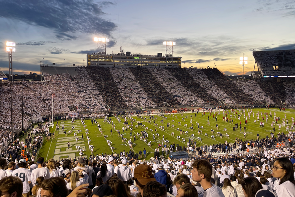 Beaver stadium filled with football fans at dusk