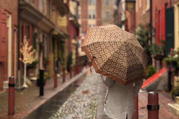 Women on street with umbrella