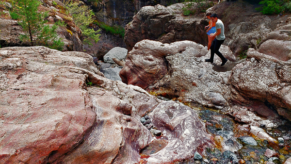 person crossing mountain creek