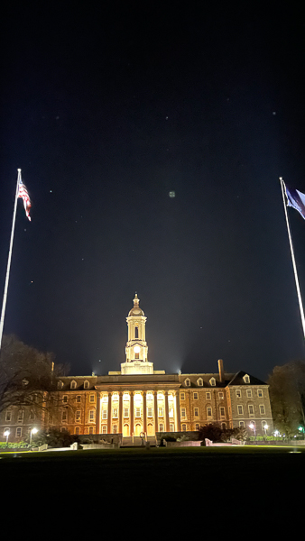 Penn Stat Old Main building at night