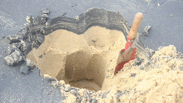 hand shovel in beach sand