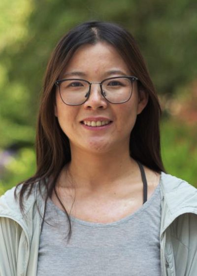 Qian Zhang smiling outside. 