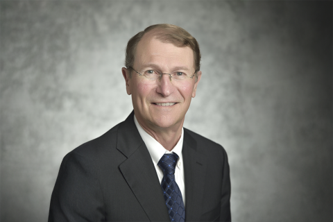 Franklin M. Orr, Jr. in grey suit and blue tie.