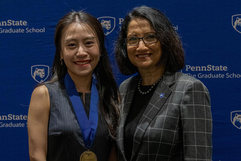 smiling student winner stands with Penn State President Neeli Bendapudi