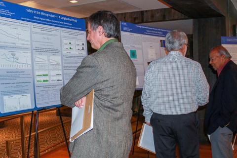 Attendees looking at research posters