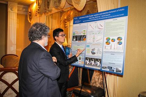 A student points at a research poster