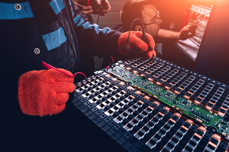 Mechanics charging EV battery