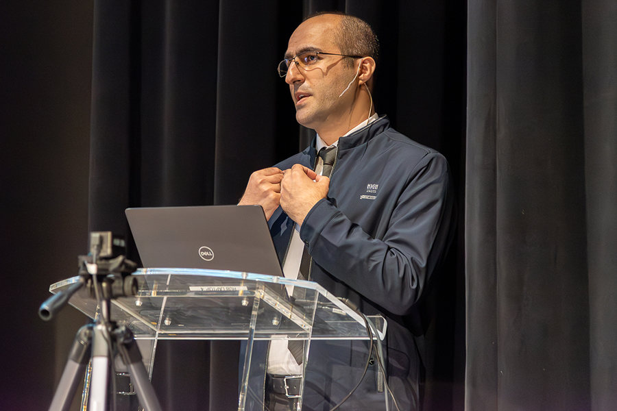 Amir Eskanlou presenting at podium