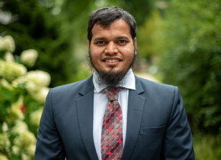 Sikandar Azam outside smiling